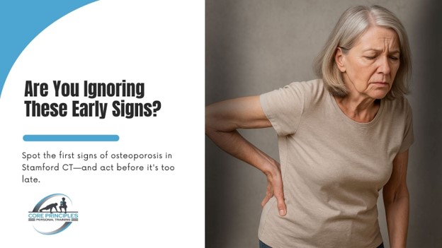 Older woman holding her lower back showing early signs of osteoporosis in Stamford CT