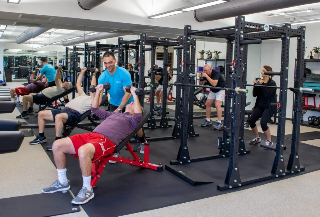 Senior man engaging in strength training with light weights in a home gym