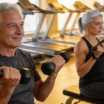 Older man and woman engaging in a fitness session with exercise equipment
